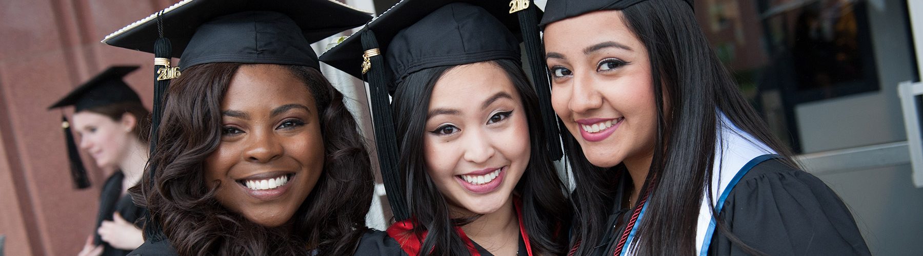 3 female students at graduation